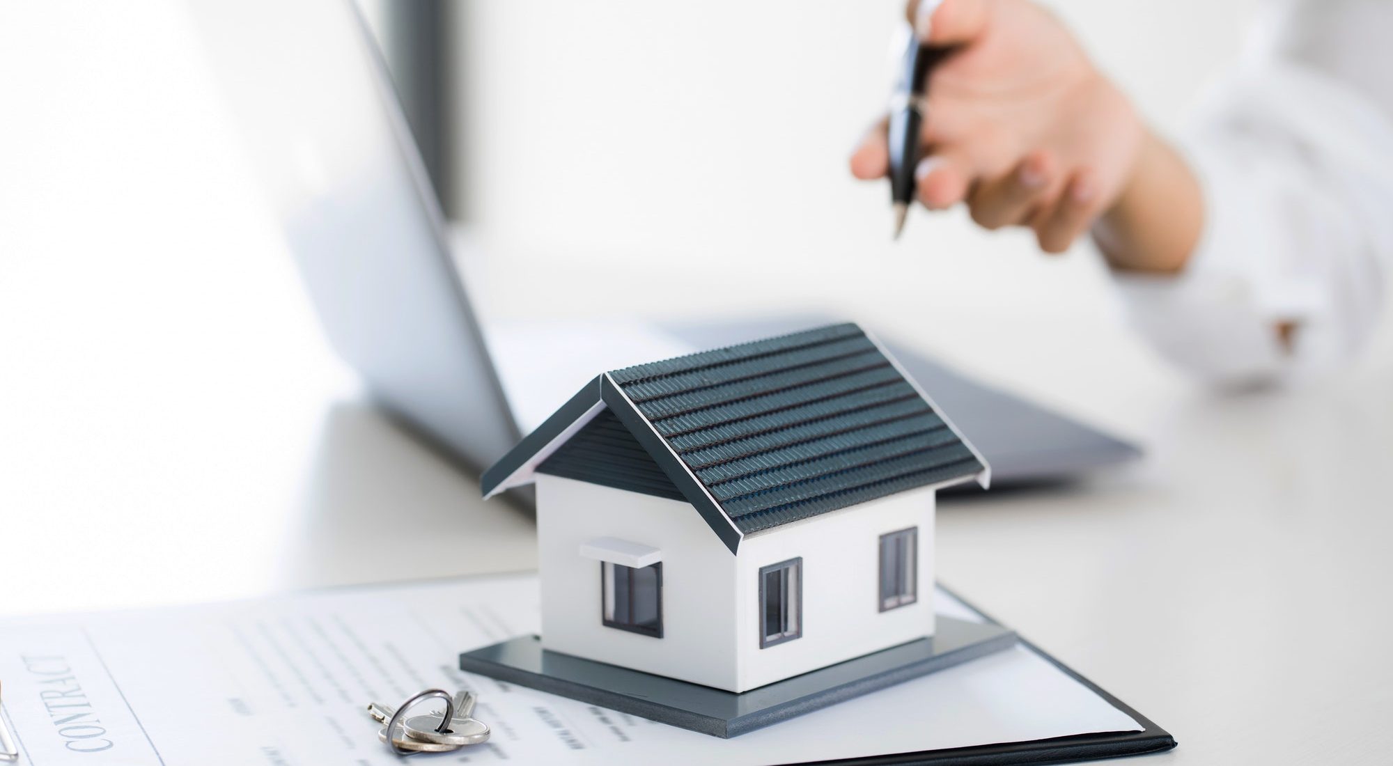 Real estate agent broker and customer with loan or insurance contract documents.